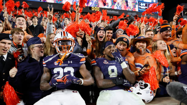 Oct 30, 2021; Auburn, Alabama, USA; Auburn Tigers cornerback Trey Elston (22) and linebacker Zakoby McClain (9) celebrate with fans defeating the Mississippi Rebels at Jordan-Hare Stadium. Mandatory Credit: John Reed-USA TODAY Sports generic